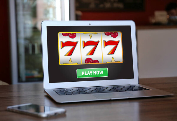 Laptop with online casino app on table indoors