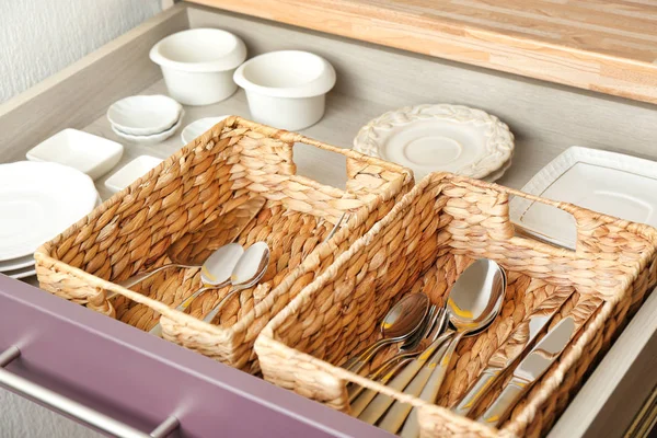 Cutlery and dishware in kitchen drawer