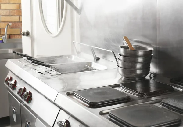 Professional equipment with cookware at restaurant kitchen