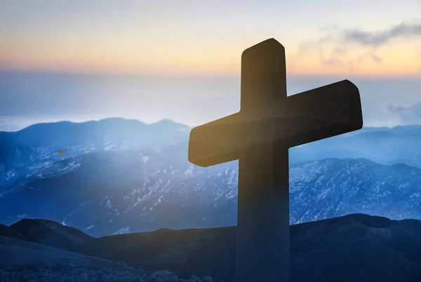Wooden cross and landscape on background. Christian religion