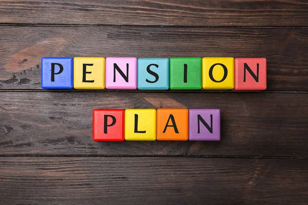 Colorful cubes with text PENSION PLAN on wooden background