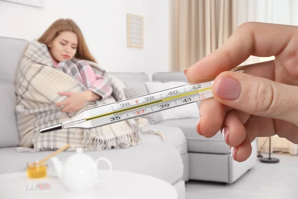 Doctor Holding Thermometer High Temperature Sick Woman Sitting Couch Home — Stock Photo, Image