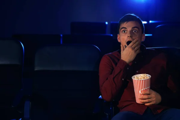 Young man watching movie in cinema