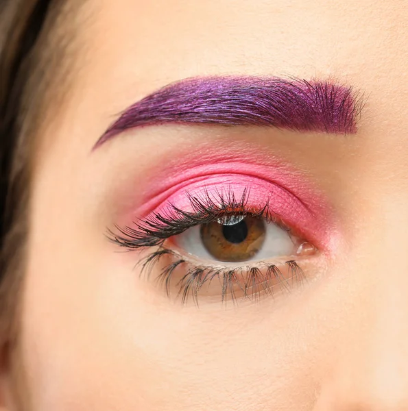 Young woman with dyed eyebrow and creative makeup on dark background, closeup Royalty Free Stock Images