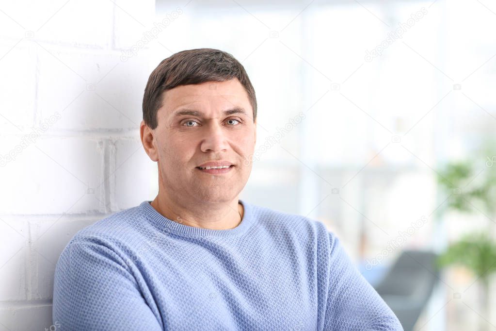 Portrait of attractive mature man at home