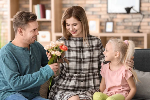 Cute little boy holding flowers for mother behind his back, closeup — Stock Photo, Image