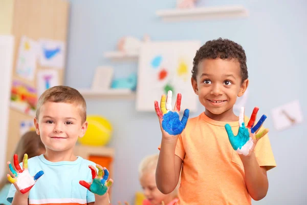 Cute boy with painted palms indoor — Stock Photo, Image