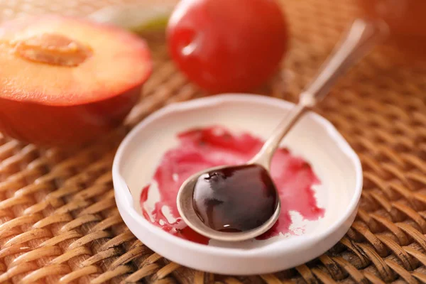 Spoon with tasty plum jam — Stock Photo, Image