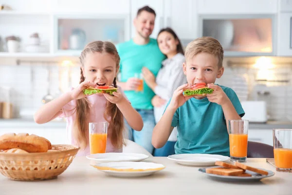 Little children having breakfast with toasts in kitchen — Stock Photo, Image