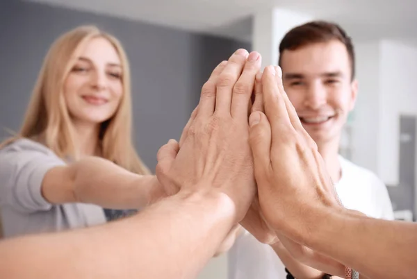 People putting hands together indoors. Unity concept — Stock Photo, Image