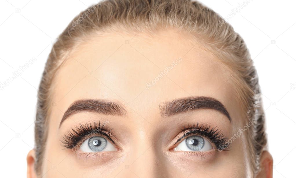 Young woman with beautiful eyebrows on white background, closeup