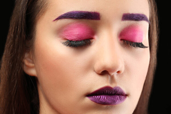 Young woman with dyed eyebrows and creative makeup, closeup