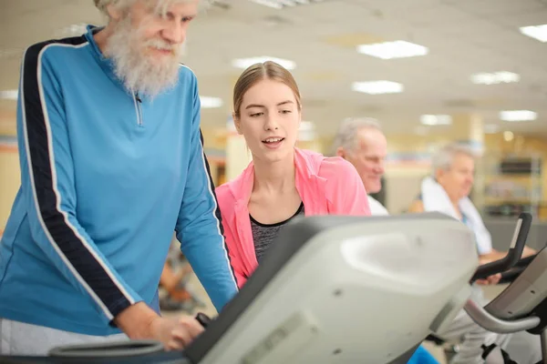 Group of elderly people in modern gym