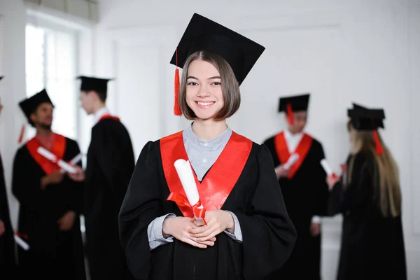 Happy Students Bachelor Robes Throwing Mortarboards Indoors Graduation Day — Stock Photo, Image