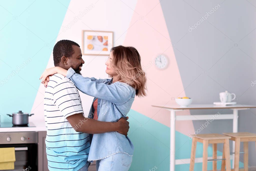 Cute interracial couple dancing at home