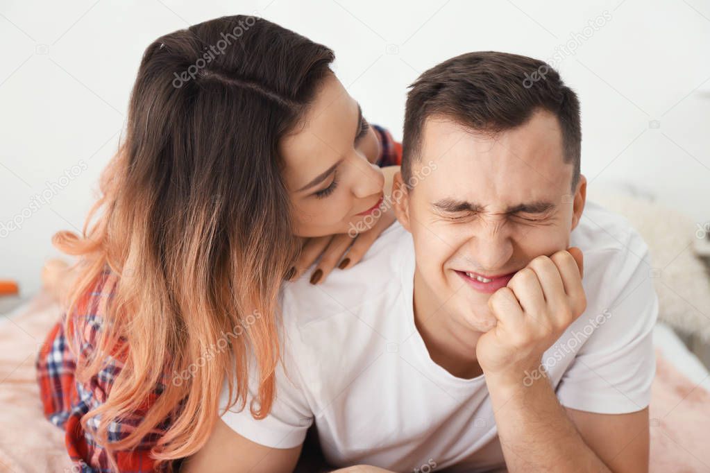 Portrait of funny young loving couple at home