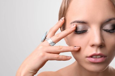 Kirpik uzantıları ışık arka plan üzerinde olan güzel kadın portresi