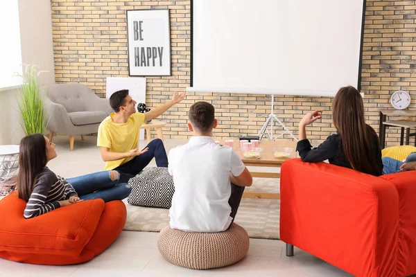 Young people watching movie in home cinema