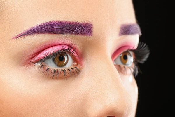 Young woman with dyed eyebrows and creative makeup, closeup