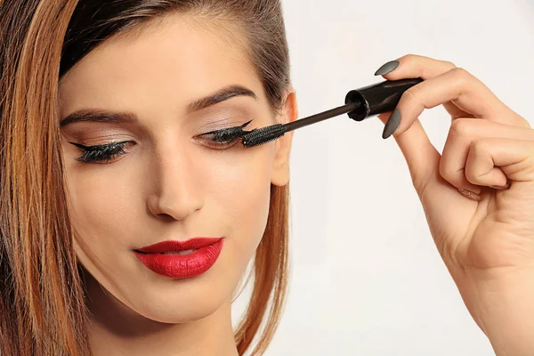 Woman Applying Mascara Her Eyelashes White Background — Stock Photo, Image