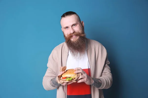 Bärtiger Mann Mit Leckerem Burger Vor Farbigem Hintergrund — Stockfoto