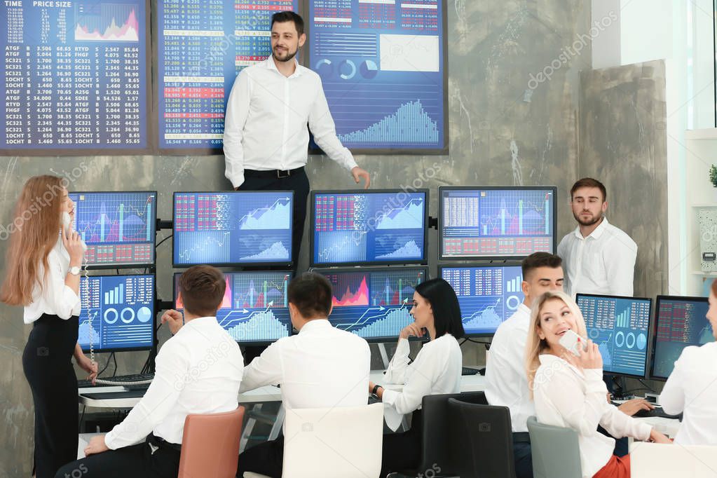 Team of stock traders working in office