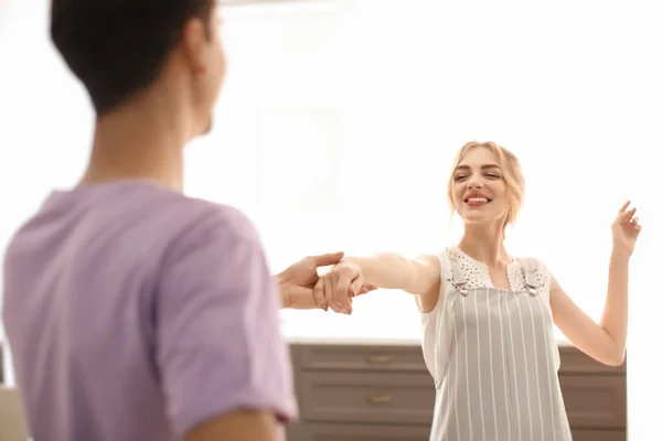 Cute young couple dancing indoors — Stock Photo, Image