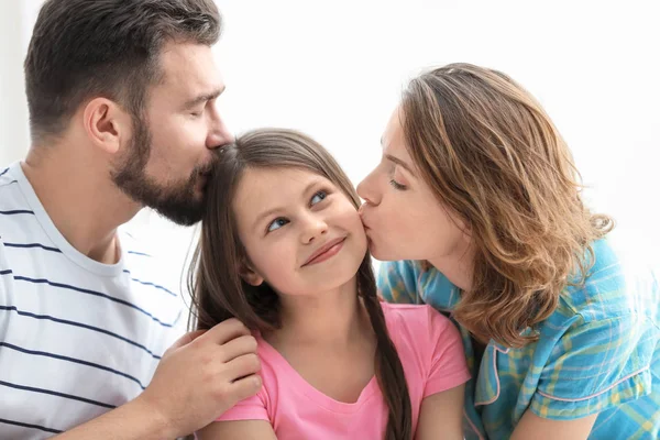Morning of happy parents with little daughter in bedroom Stock Image