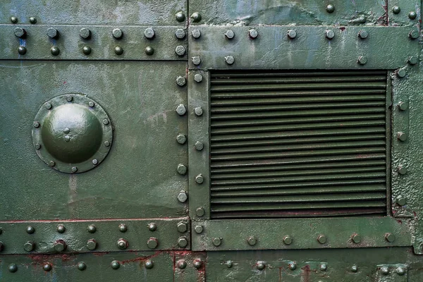 Cıvata ve perçinli yeşil endüstriyel metal arka plan dokusu. Eski boyanmış metal arka plan, askeri uçağın detayları, yüzeyde aşınma, perçinli metal doku.