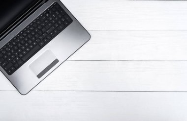 Ahşap beyaz ofis resepsiyon masası ile açık boş dizüstü bilgisayar, boş alan. Üstten görünüm kopya alanı ile. Ahşap arka plan gri laptop