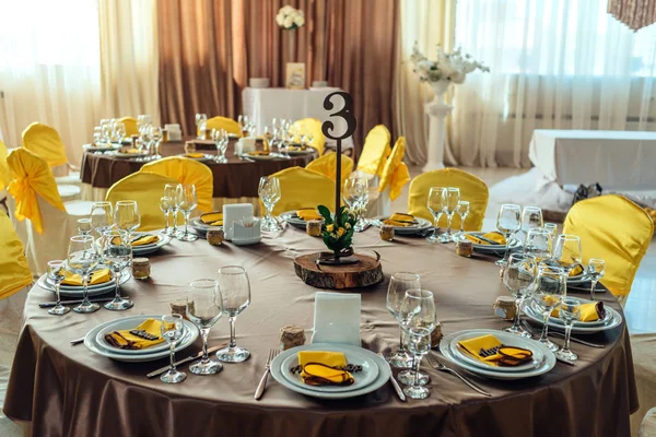 Table served for wedding banquet. Table setting. Number of guest table at wedding banquet
