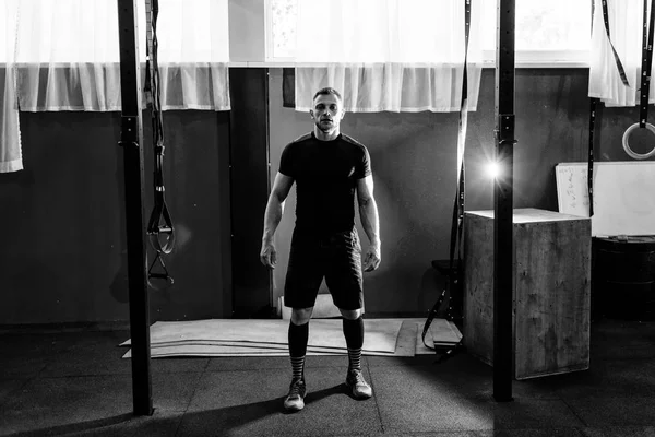 Muscular bearded man preparing to training his biceps and back in gym. Pull-ups. Workout lifestyle concept. Full body length portrait