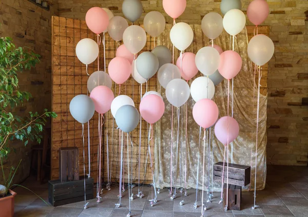 Wedding or birthday photo zone with white, pink and gray balloons in front of wooden screen, free space. Colorful balloons background, pink, white, grey. Holiday concept