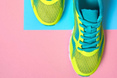 Çift spor ayakkabı renkli arka plan üzerinde. Pembe ve mavi pastel arka plan, kopya alanı üzerinde yeni spor ayakkabıları. Genel gider atış koşu ayakkabıları. Üstten görünüm, düz yatıyordu