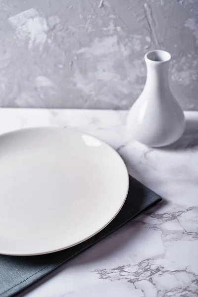 Empty White Plate Gray Napkin Vase Table Grey Rough Plaster — Stock Photo, Image