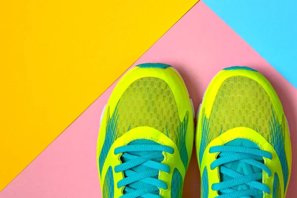 Pair of sport shoes on colorful background. New sneakers on pink