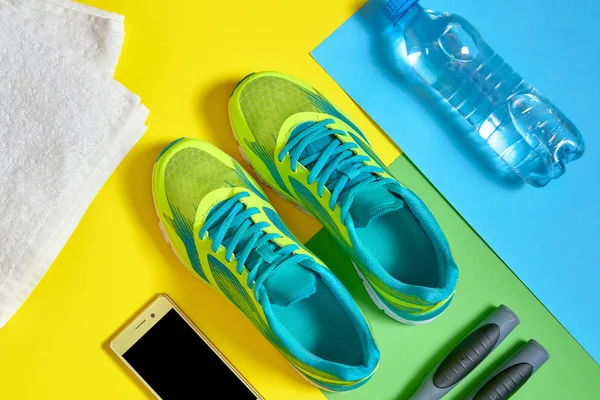 Top view of sport shoes, mobile smartphone, skipping rope, towel