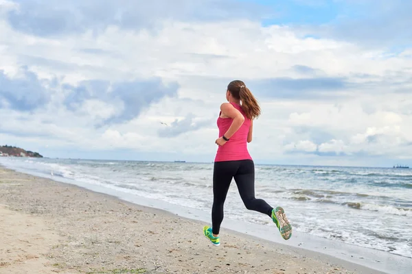 Widok z tyłu młodej kobiety fitness biegacza biegnąca na wybrzeżu, Kopiuj — Zdjęcie stockowe