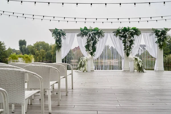 Place for wedding ceremony with wedding arch decorated with palm