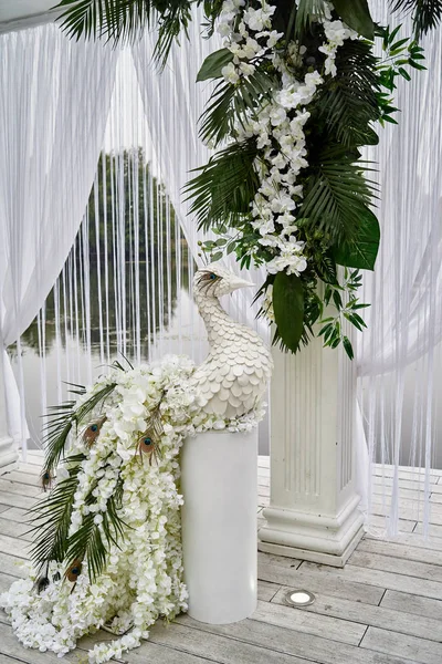 Luxury floral decor for wedding ceremony with palm leaves, orchi