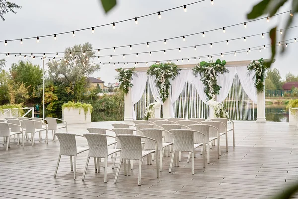 Place for wedding ceremony with wedding arch decorated with palm