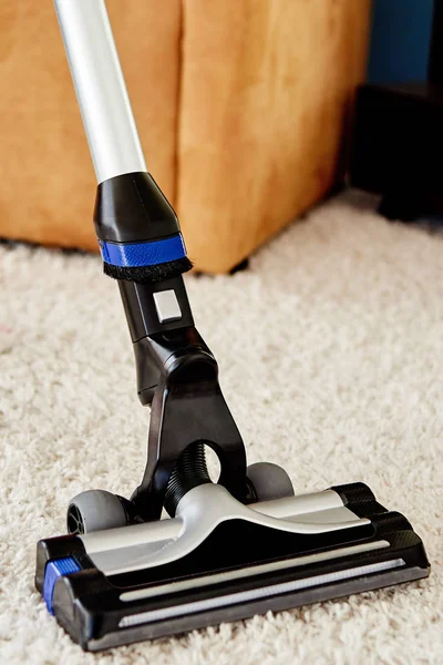 Close up of modern vacuum cleaner on beige carpet on floor in li — Stock Photo, Image