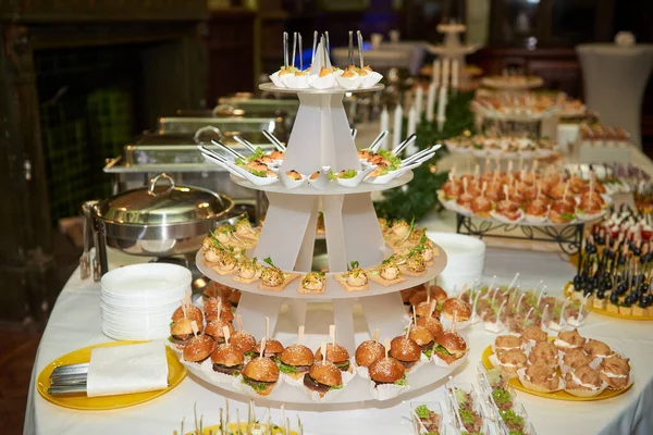 Buffet table with snacks canape and appetizers at luxury weddin
