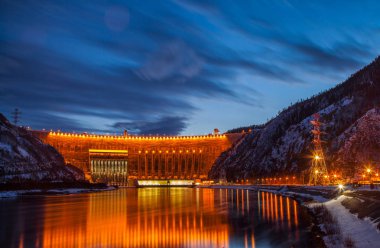 Sayano Shushenskaya hydroelectric station in the winter evening clipart