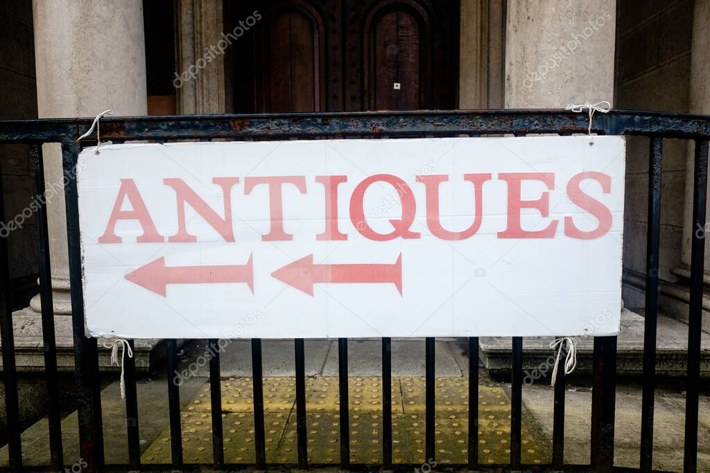 antiques sign on old iron railings in Ulverston UK