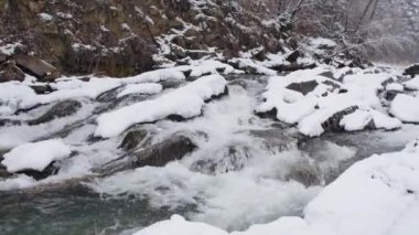 White water river in winter. World covered in snow.