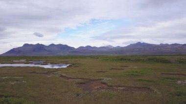 İzlanda 'da manzara. Yeşil çayırdaki küçük gölcükler.