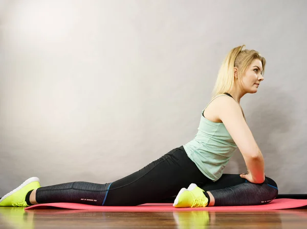 Young Blonde Woman Sportswear Sitting Wooden Floor Indoor Stretching Legs — Stock Photo, Image