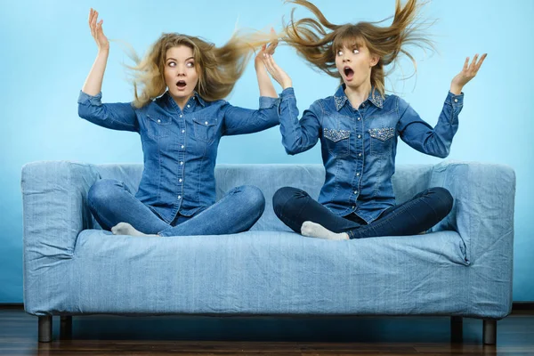 Two Shocked Women Wearing Jeans Shirts Having Windblown Blonde Hair — Stock Photo, Image