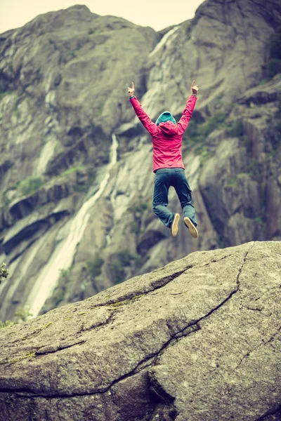 Happy Woman Jumping Rock Grey Mountains Enjoying Traveling Adventure — Stock Photo, Image